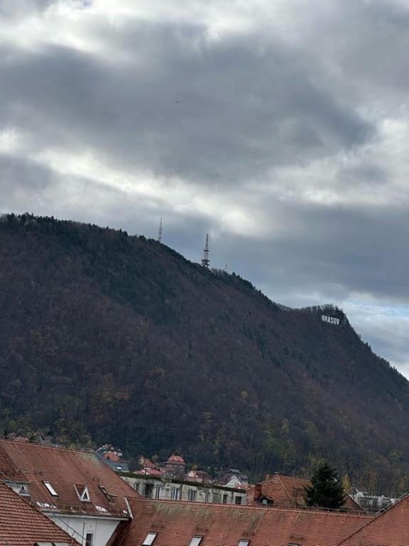 a hill with a lighthouse on top of a mountain at central place in Braşov