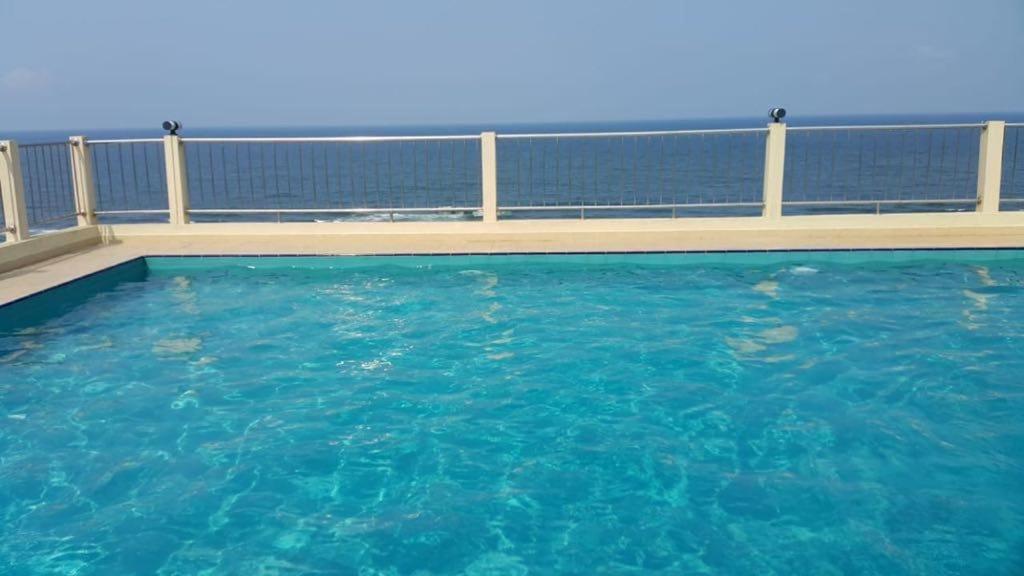 a large pool of blue water on a balcony at SEA BREEZE HOLIDAYS HOME in Colombo