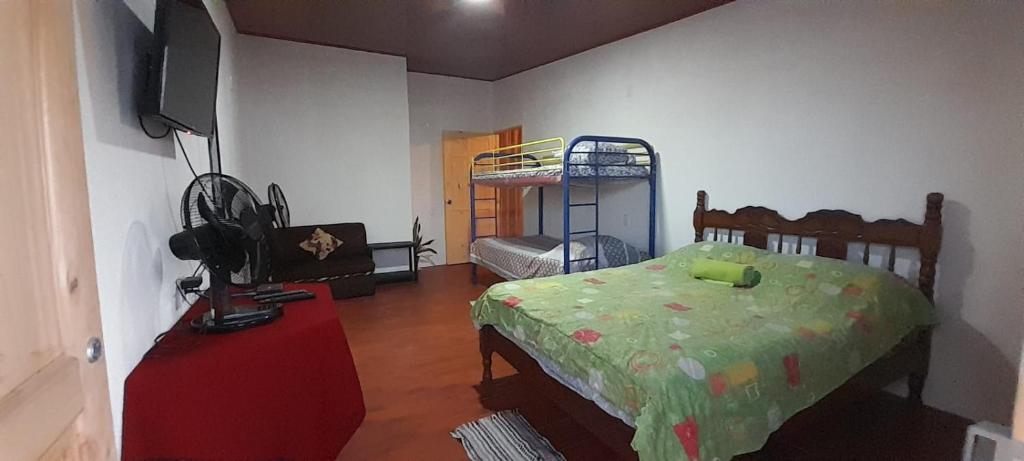 a bedroom with a bed and a bunk bed at Stay-ya, Diplo's Street in Puerto Limón