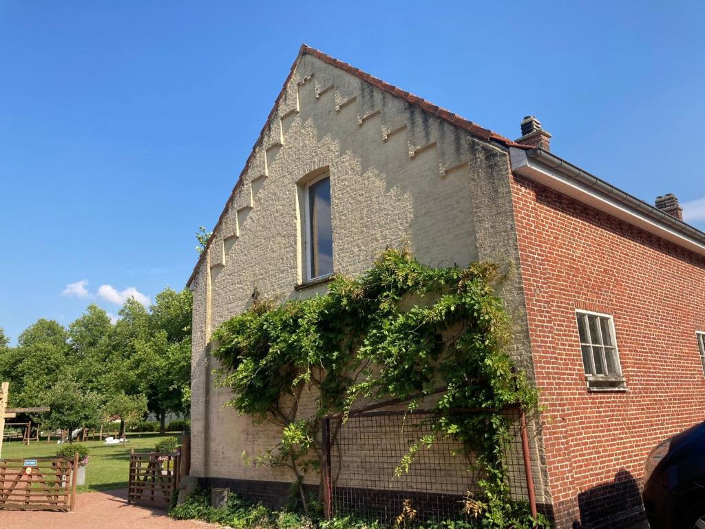 an old brick building with vines on it at Nice apartment on UNESCO World Heritage Site Wortel Kolonie 