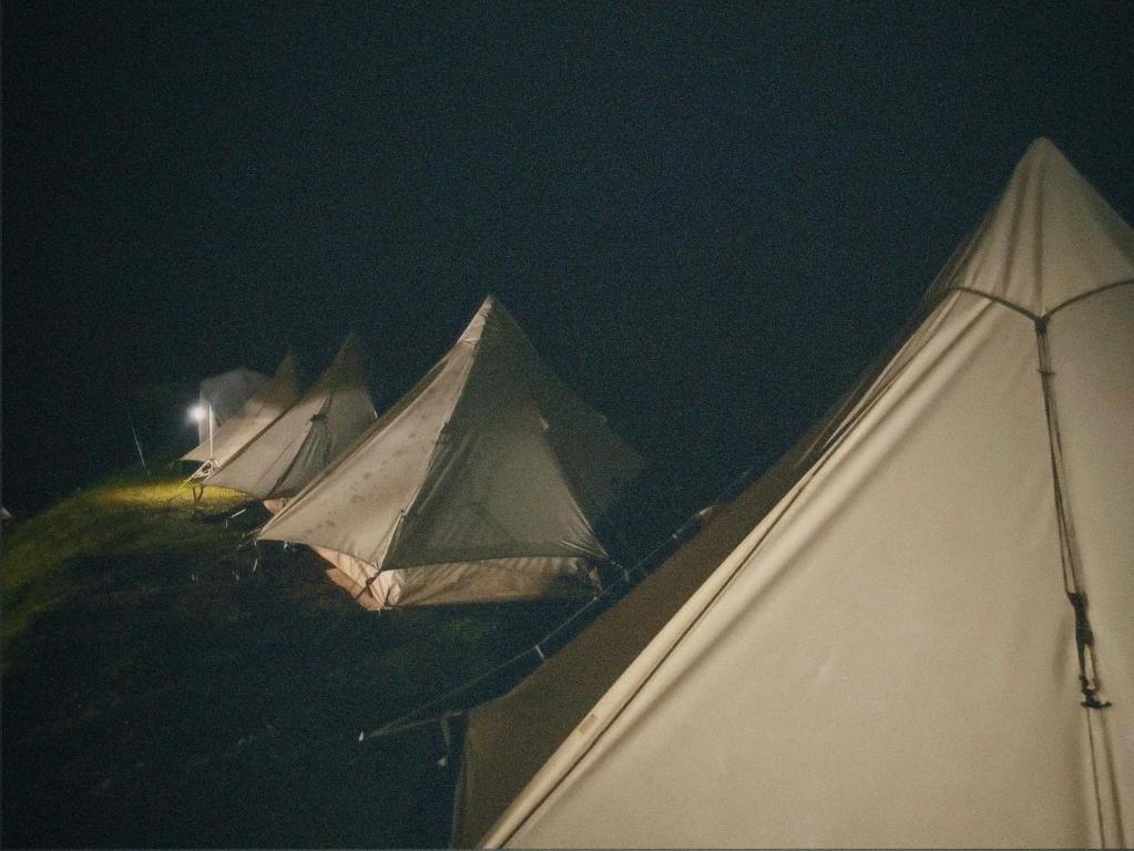 a group of tents sitting on top of a field at night at Camping Núi Thủng ở Cao Bằng in Cao Bằng