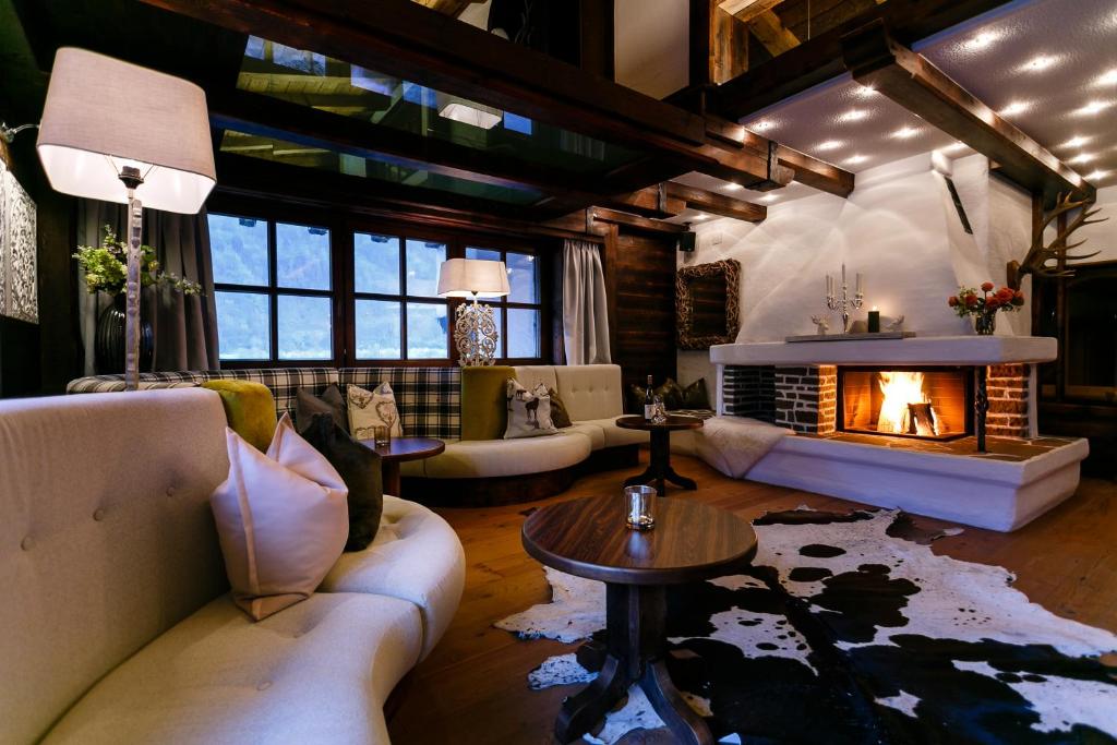 a living room with a couch and a fireplace at Villa22 Oetz in Oetz