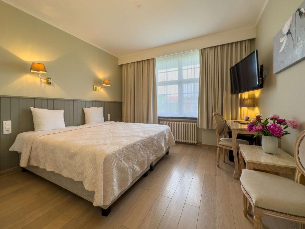 Postel nebo postele na pokoji v ubytování Hotel Pavillon Du Zoute