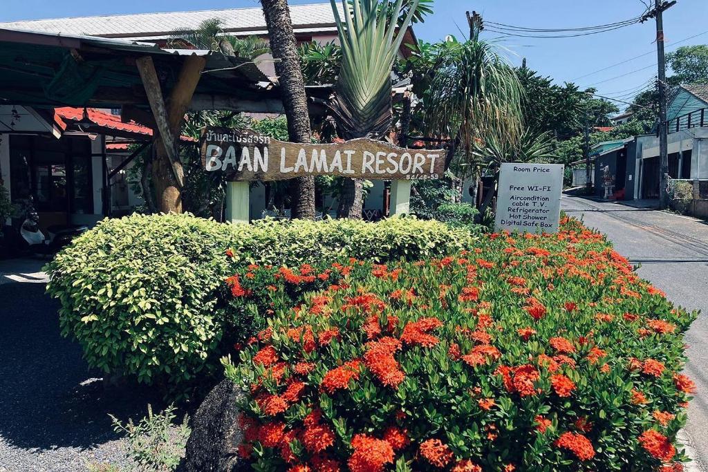 a sign in front of a haw lamuana resort with flowers at Baan Lamai Resort in Lamai
