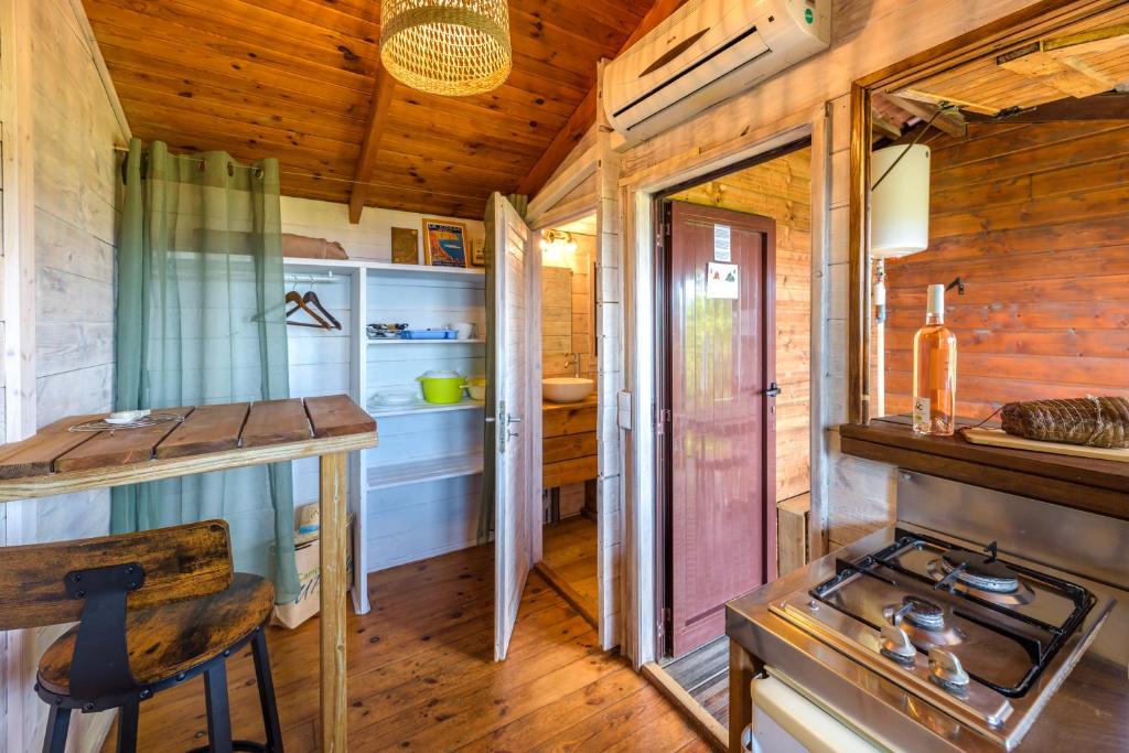 a kitchen in a tiny house with a stove at Camping U Pirellu in Porto-Vecchio