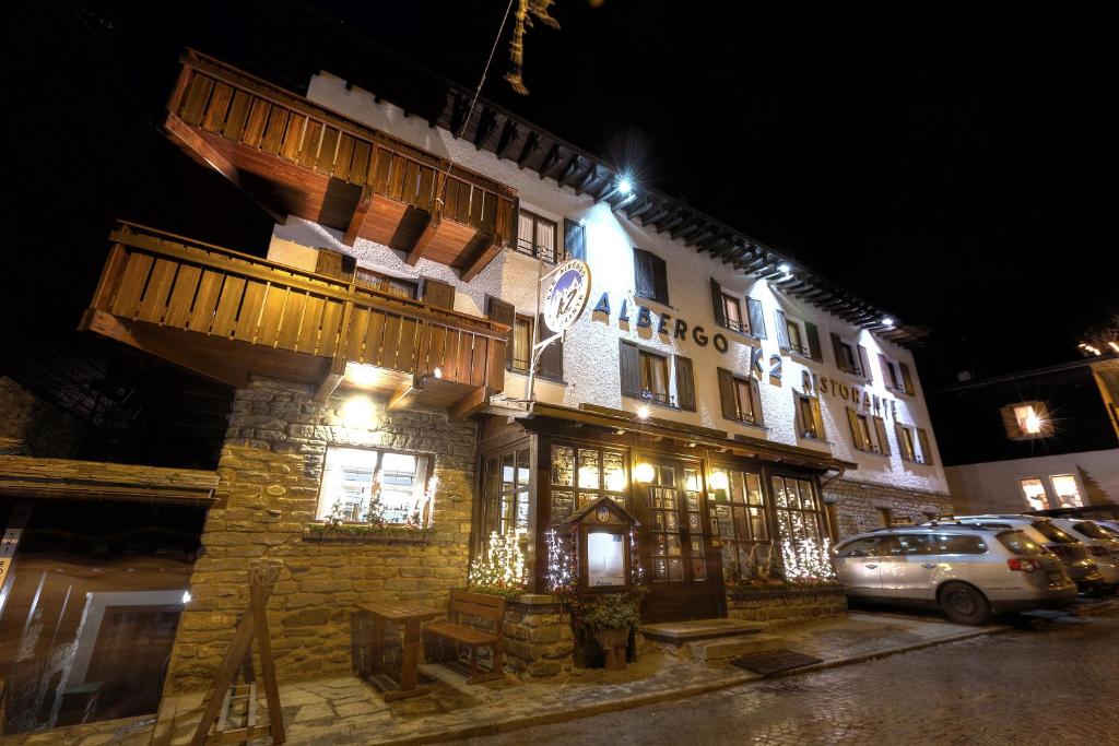 a building with a clock on it at night at Albergo K2 in Madesimo