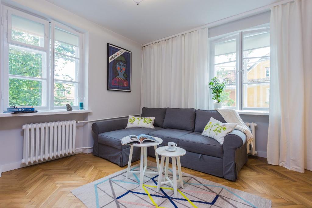 a living room with a couch and a table at Baker Street in Warsaw