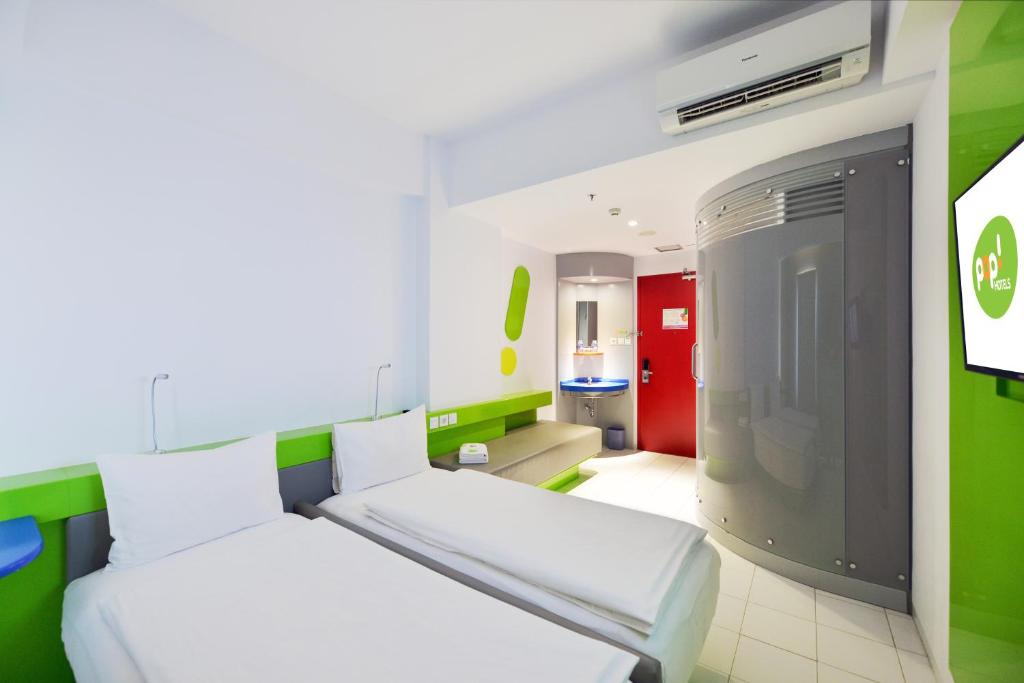 Postel nebo postele na pokoji v ubytování POP! Hotel Tanjung Karang