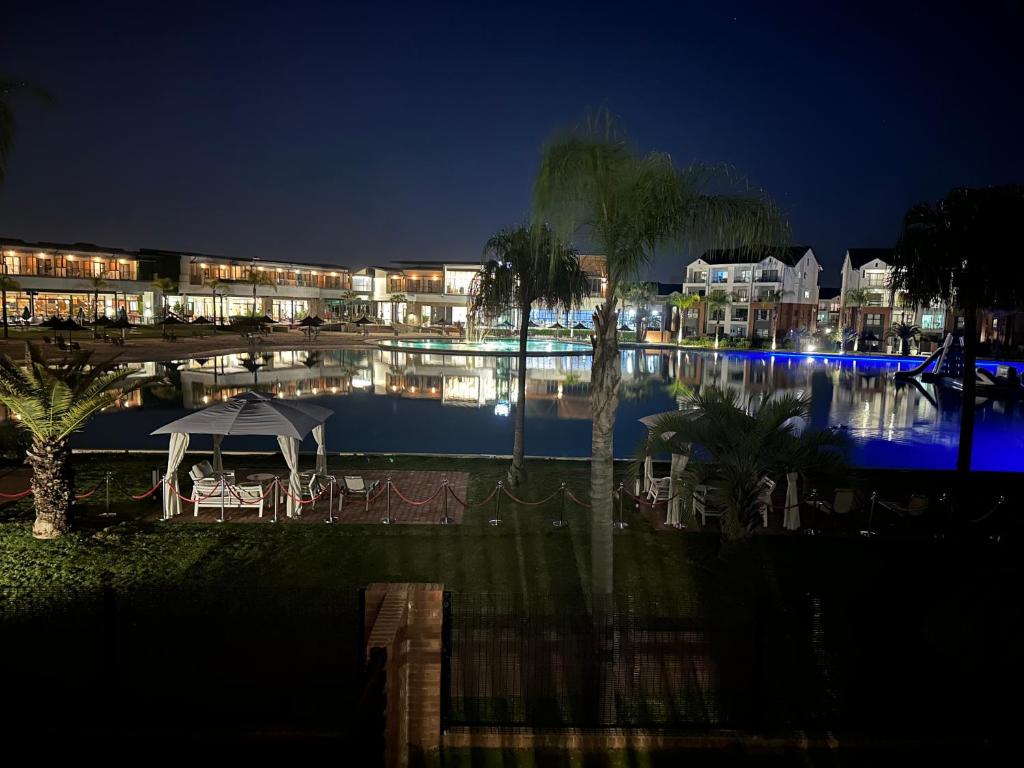 a resort with a swimming pool at night at Lagoon facing The Blyde in Pretoria
