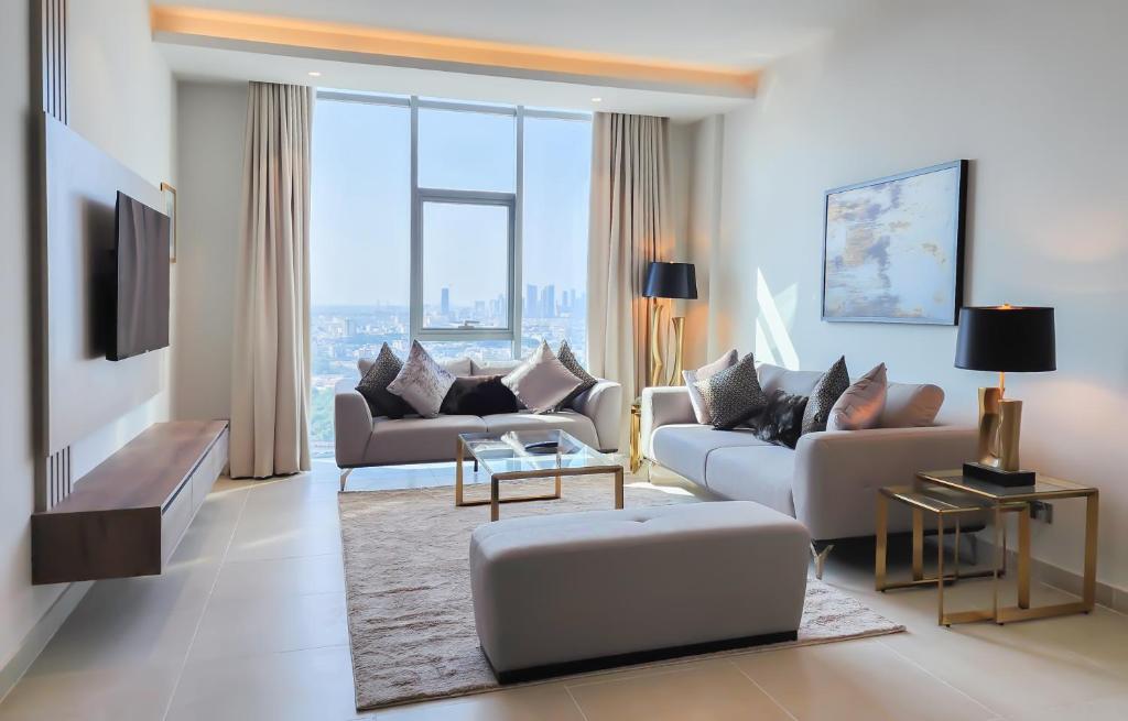 a living room with couches and a large window at Farhan Tower in Juffair
