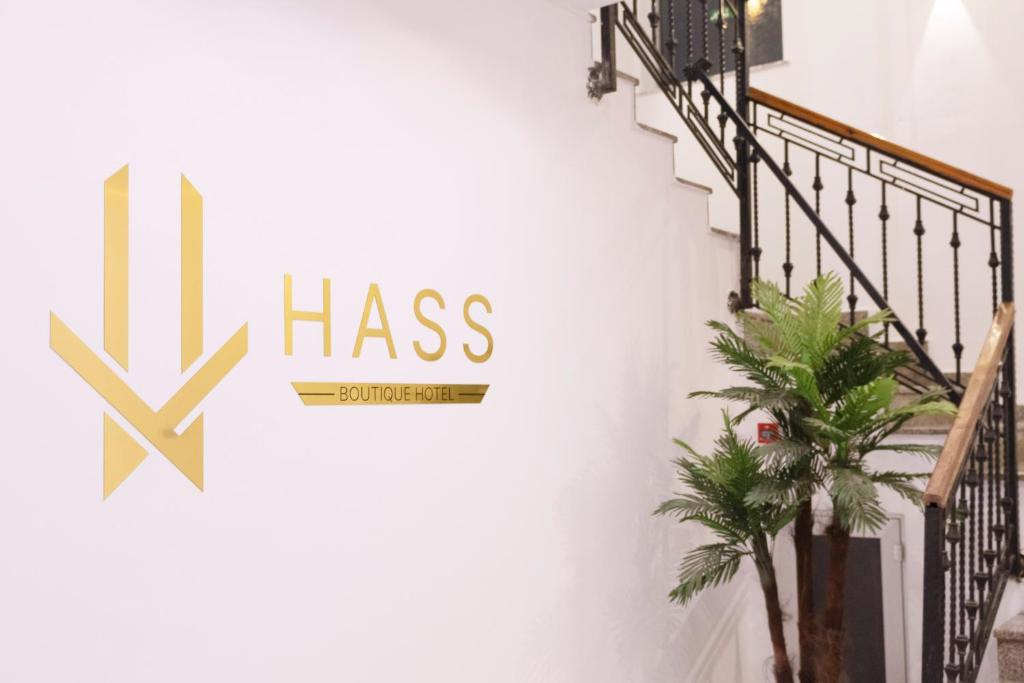 a staircase with a sign that says hhas on a wall at HASS Boutique Hotel in Gostivar