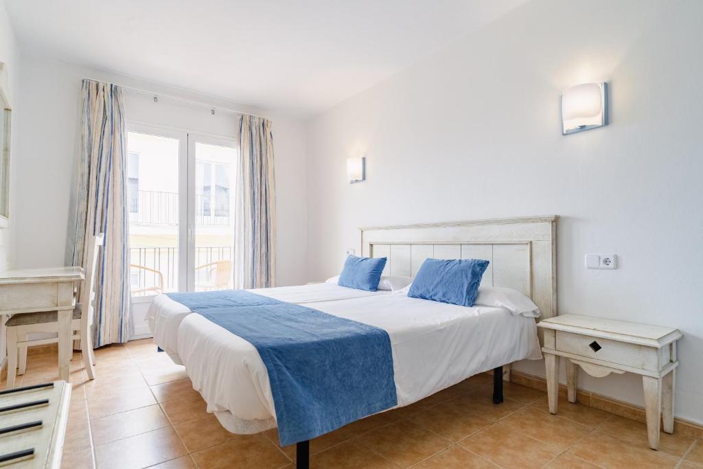 Voodi või voodid majutusasutuse Hostal HPC Porto Colom toas