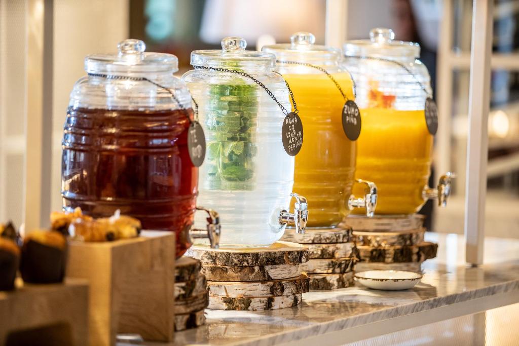 a row of jars of honey on a table at INNSiDE by Meliá Tenerife Santa Cruz in Santa Cruz de Tenerife