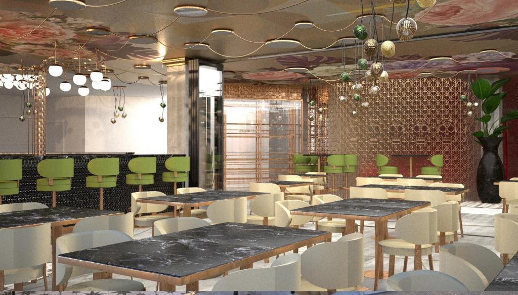 a dining room with tables and white chairs at INNSiDE by Meliá Tenerife Santa Cruz in Santa Cruz de Tenerife