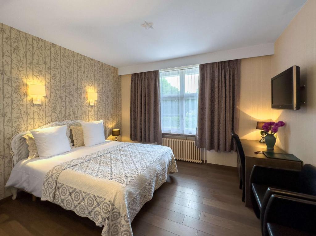 Postel nebo postele na pokoji v ubytování Hotel Pavillon Du Zoute