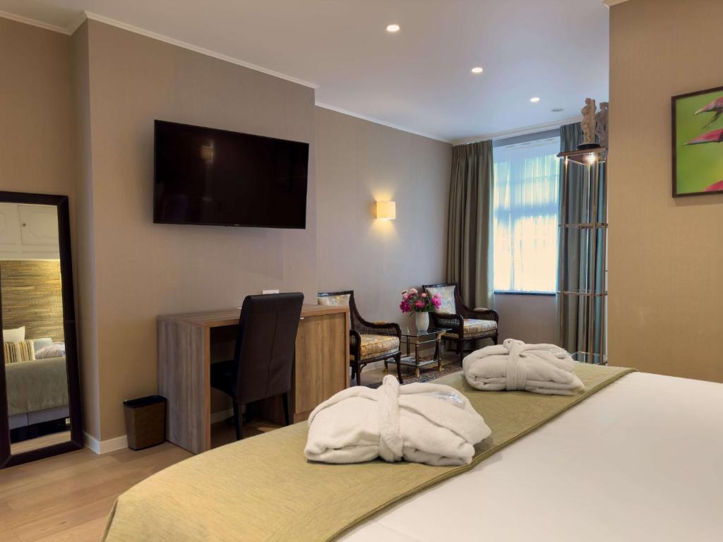 Postel nebo postele na pokoji v ubytování Hotel Pavillon Du Zoute