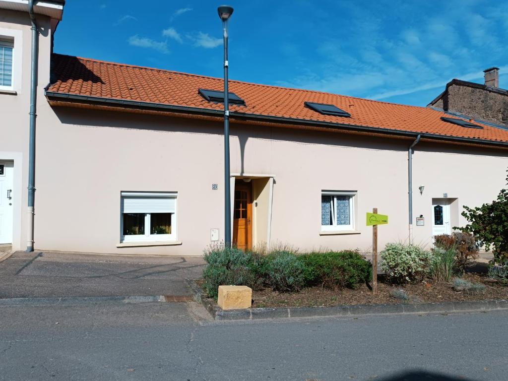 a white building with a red roof at La maison de mamie rdc 