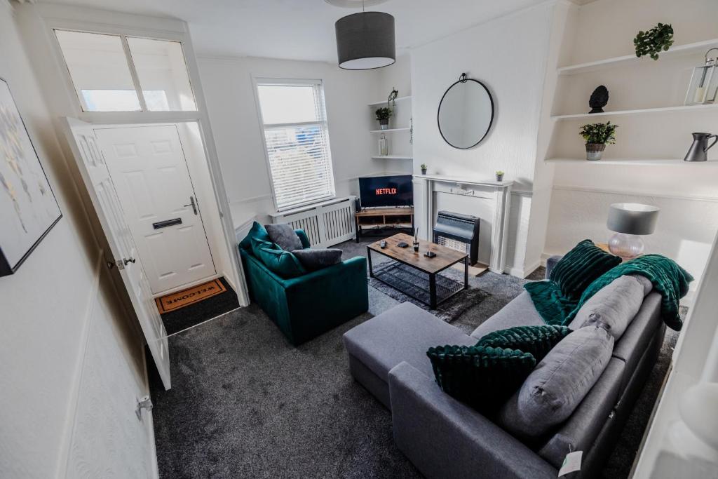 a living room with a couch and a fireplace at The Nest In Blackburn in Blackburn