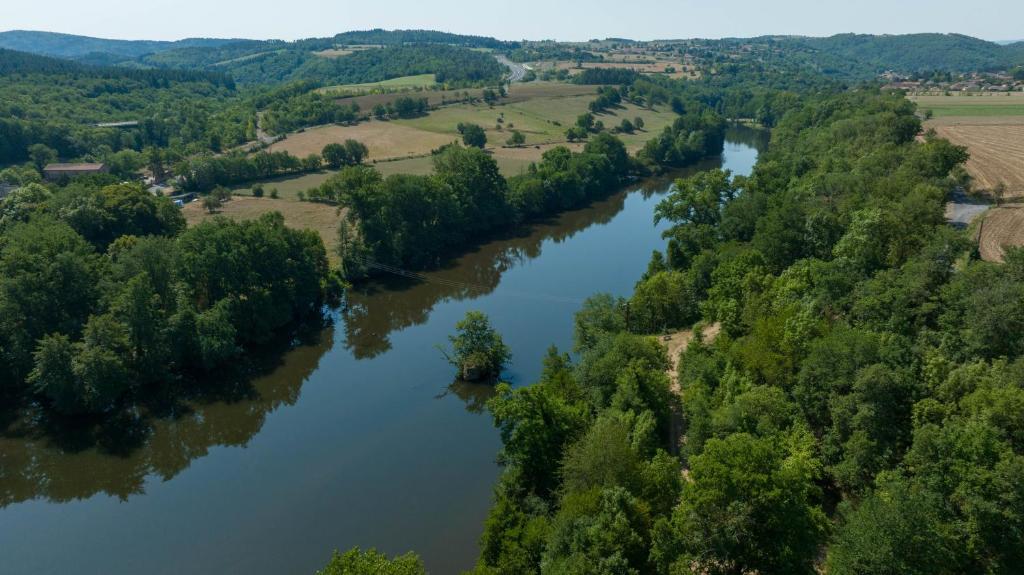 an aerial view of a river with trees and fields at Camping de la Bageasse in Brioude