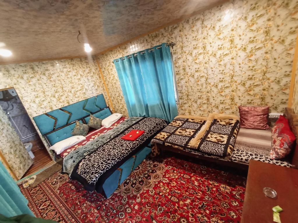 1 dormitorio con 2 camas y alfombra en Hb nancy group of houseboats, en Srinagar