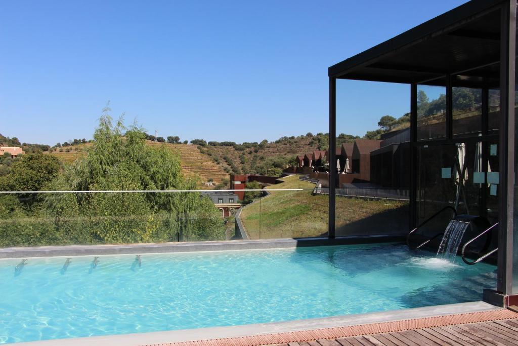 a large swimming pool with a view of a hill at Longroiva Hotel Rural in Longroiva