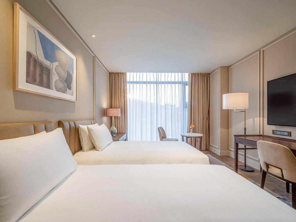 Cama ou camas em um quarto em The Ambassador Seoul - A Pullman Hotel