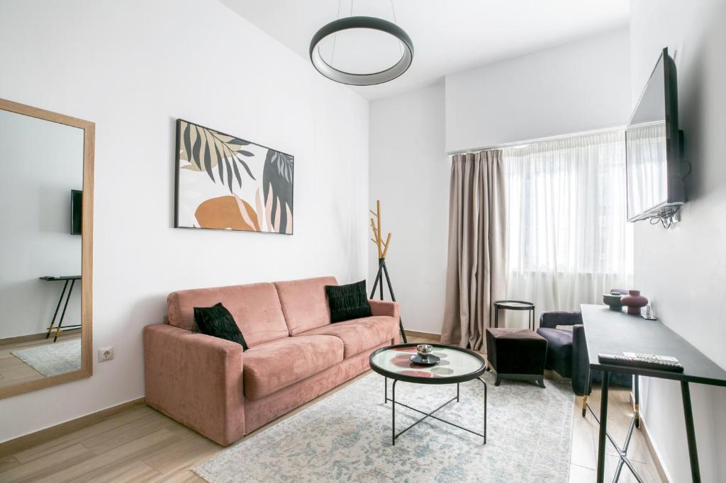 ein Wohnzimmer mit einem Sofa und einem Tisch in der Unterkunft Elia Kolonaki Luxury Apartments in Athen