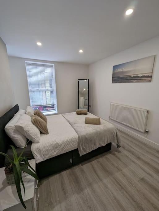 a bedroom with a large bed in a room at Bold street apartment in Liverpool