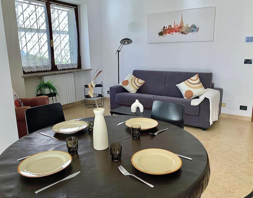 uma sala de estar com uma mesa e um sofá em Appartamento indipendente a Mirafiori Sud em Turim