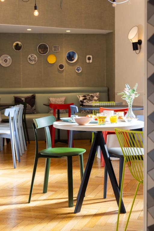 a dining room with a table and chairs at Hôtel Vendôme in Nice