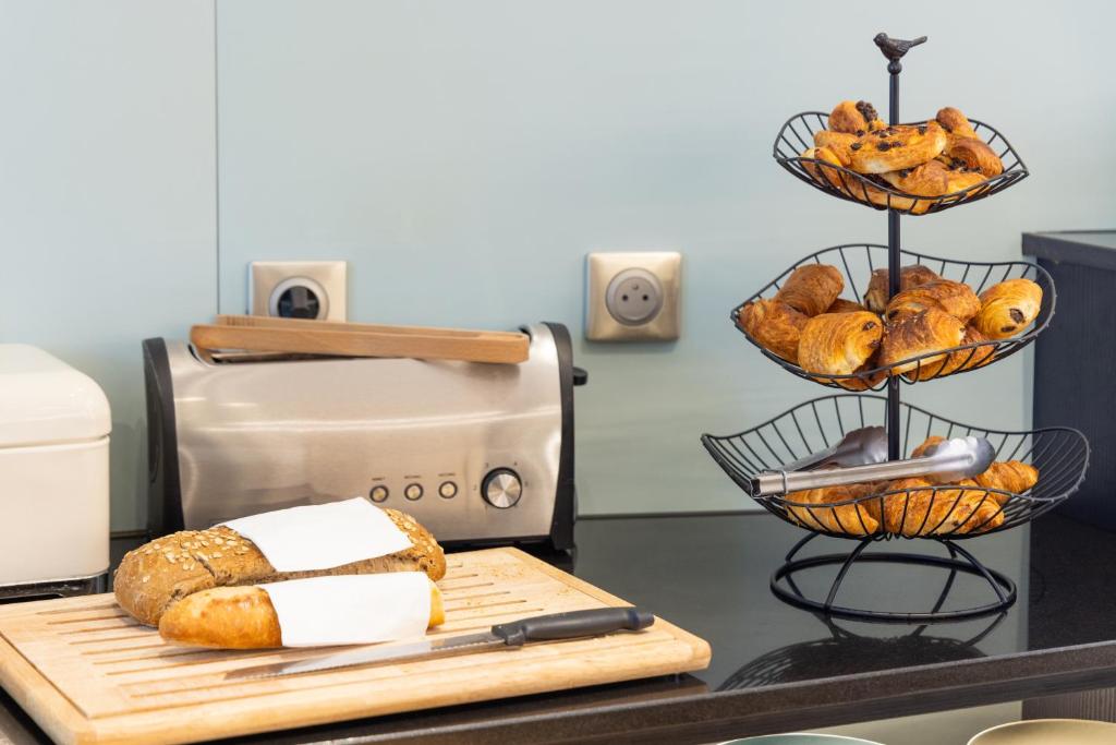 a bunch of breads on a counter next to a toaster at Hôtel Vendôme in Nice