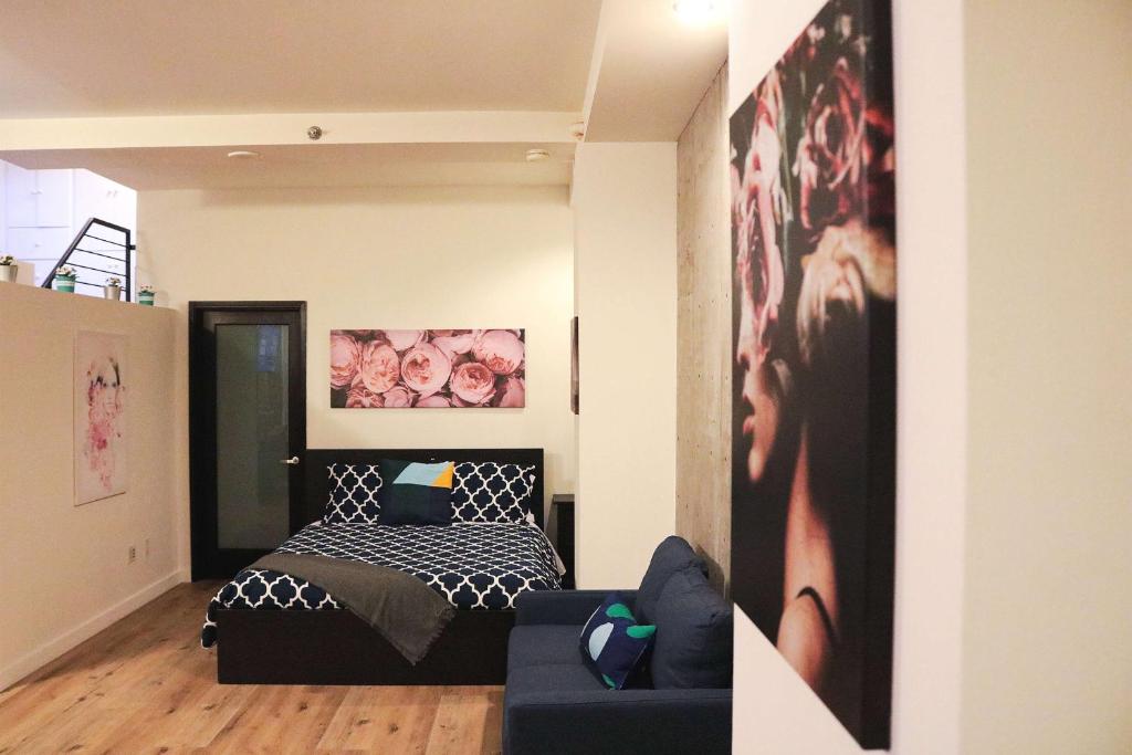 a bedroom with a black and white bed and a couch at The Haas, Trademark Collection by Wyndham in Los Angeles