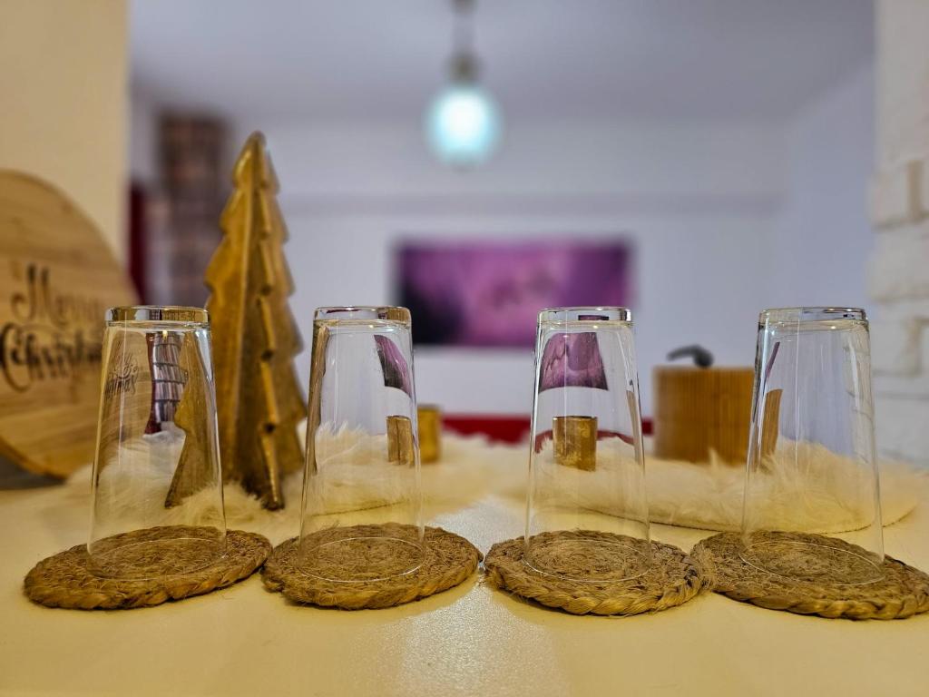 three wine glasses and cookies on a table at Anastasia Crib in Craiova