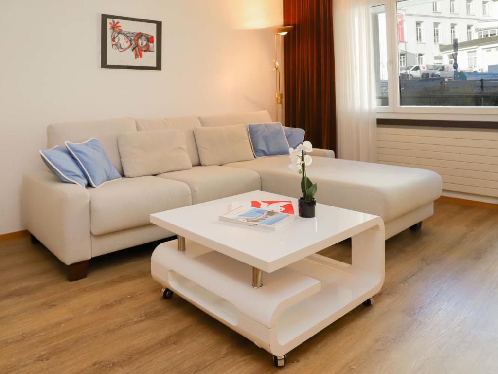 a living room with a couch and a coffee table at Apartment Allod-Park-6 by Interhome in Davos