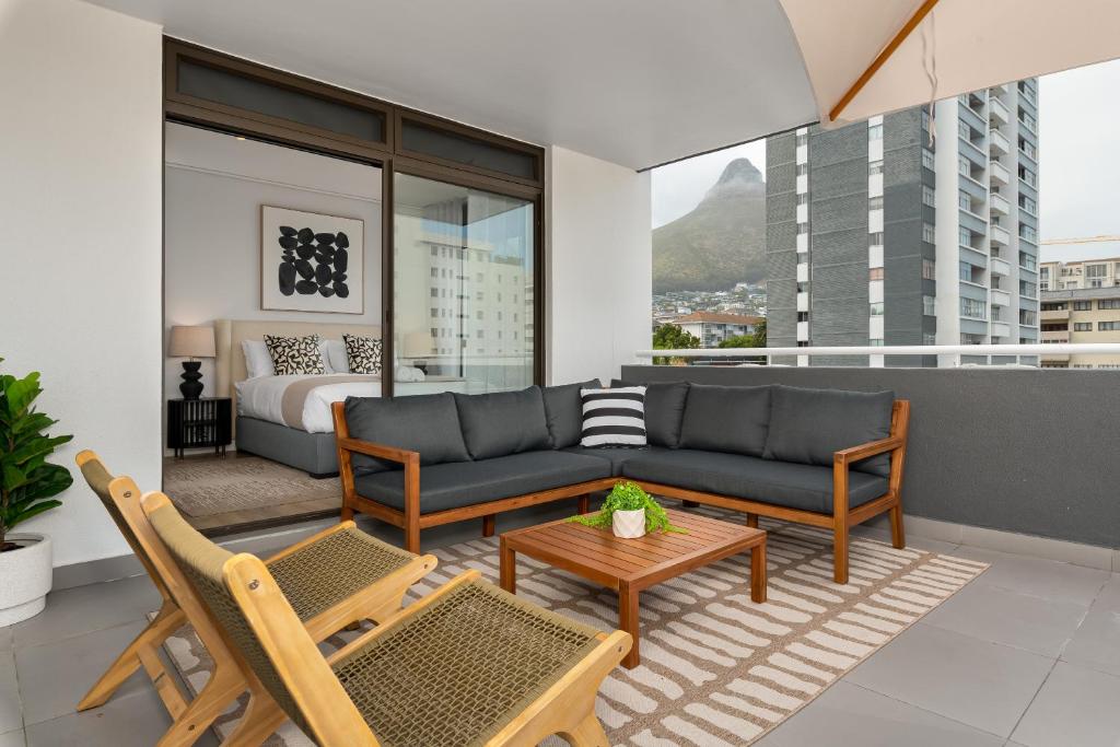 a living room with a couch and a bed at Suro Luxury Apartments in Cape Town