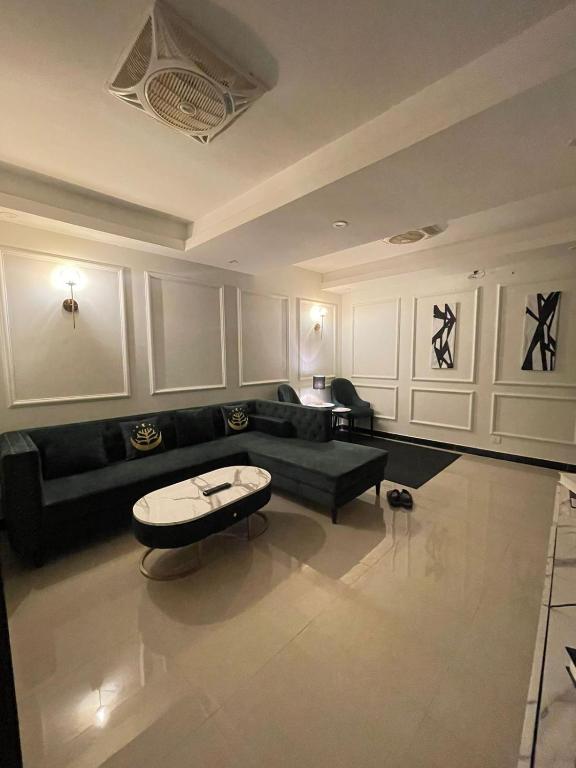 a living room with a couch and a table at French 2-bed in Rawalpindi