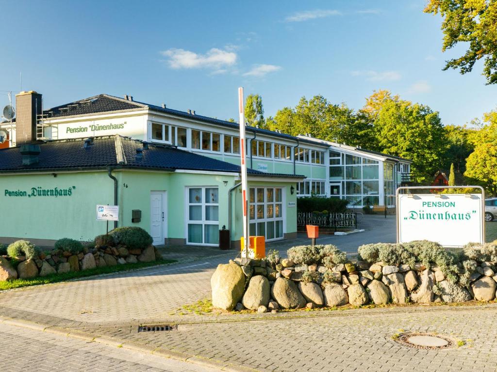 a building with a sign in front of it at Apartment Dünenhaus App- 104 by Interhome in Zempin