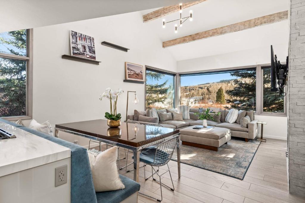 a kitchen and living room with a table and chairs at Snowmass Villas 3 plus loft in Snowmass Village