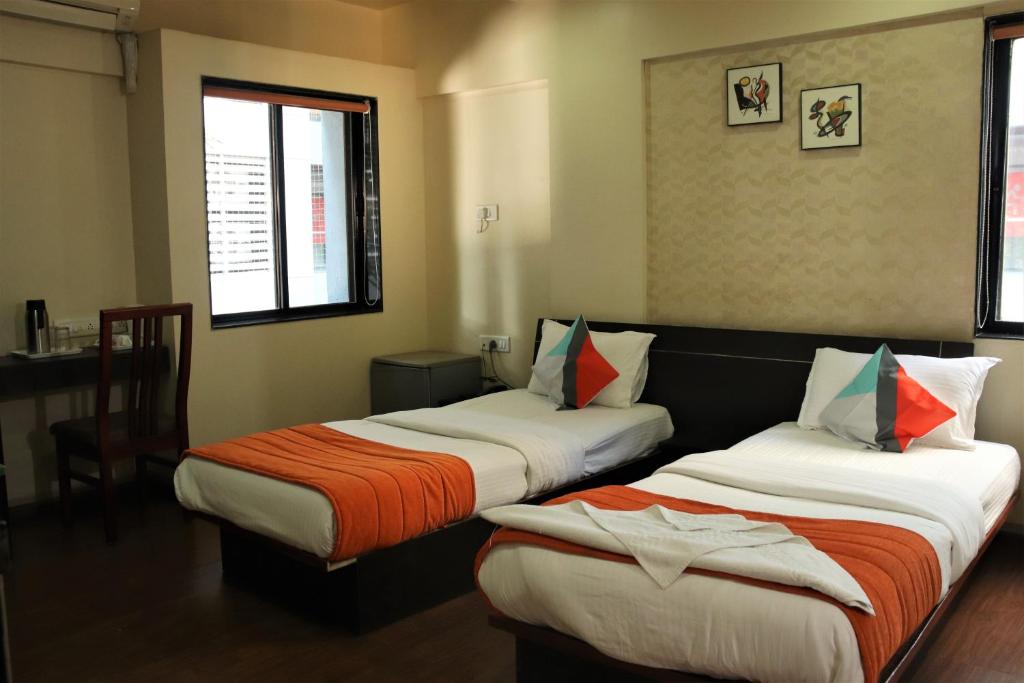 a room with two beds in a room at Hotel Serene Viman Nagar in Pune