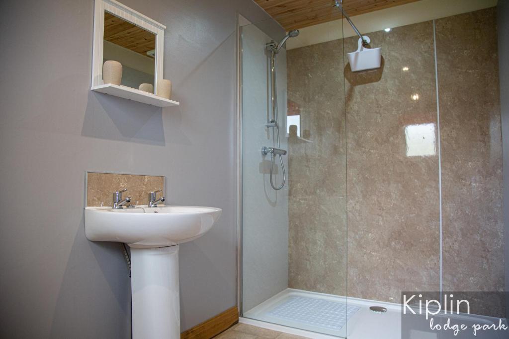 a bathroom with a sink and a shower at Essex Lodge in Richmond