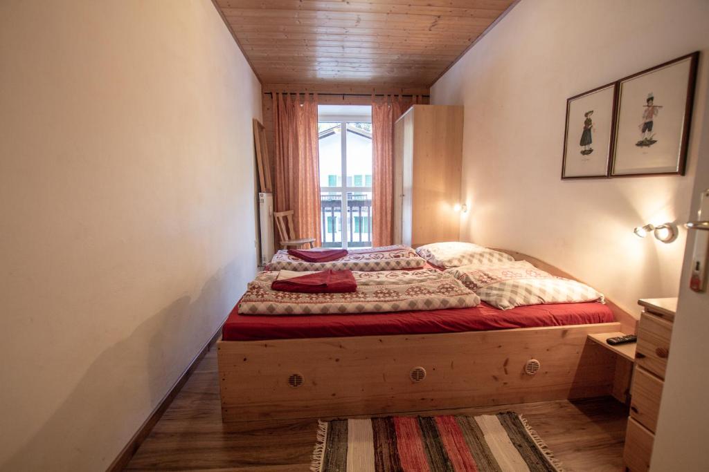 a bedroom with a bed in a room with a window at Apartment Paletti 23 in Enzingerboden