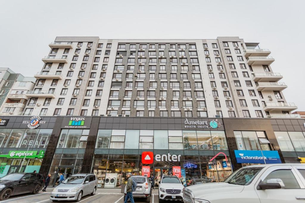 a large building with cars parked in front of it at Comfortable apartments. Good location. in Chişinău