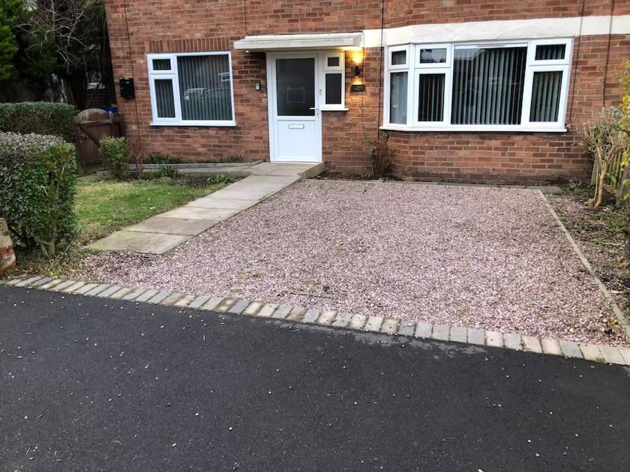 a house with a lot of gravel in front of it at Entire 2 bed modern apartment in Nantwich