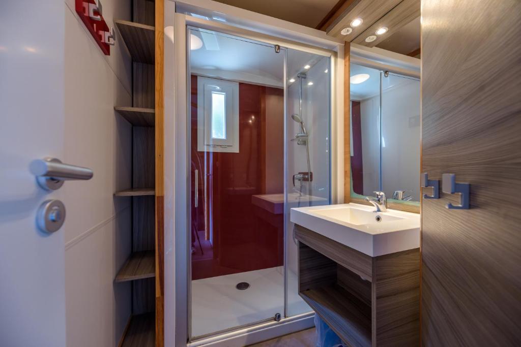 a bathroom with a sink and a shower at Camping U Pirellu in Porto-Vecchio
