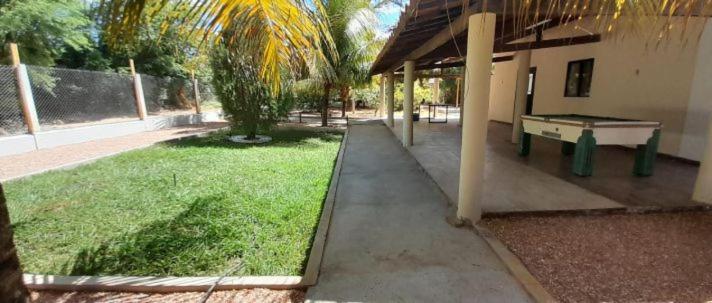 a yard with a ping pong table next to a building at Chalé Brisas do rio espaço privativo ideal para casal ou família in Petrolina