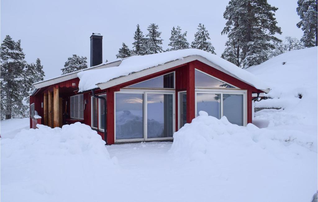 a red house covered in snow with snow around it at Cozy Home In Noresund With Kitchen in Noresund