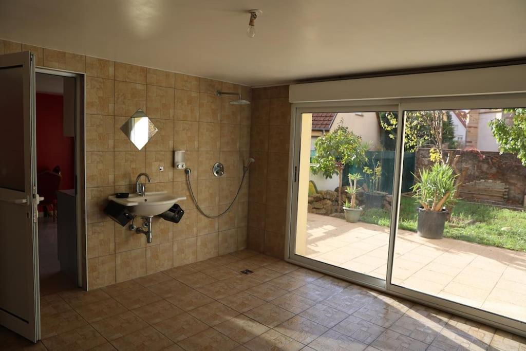 a bathroom with a shower and a sink in a room at Villa avec piscine intérieure in Holtzheim