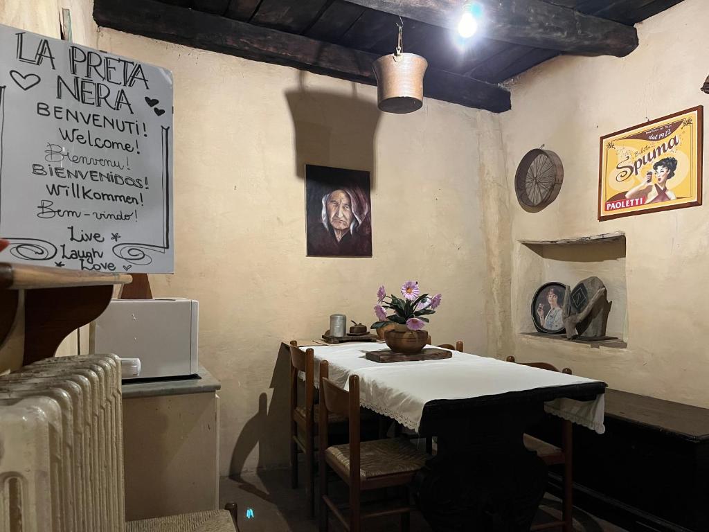 a dining room with a table with a white table cloth at La Preta Nera in Giuliano di Roma