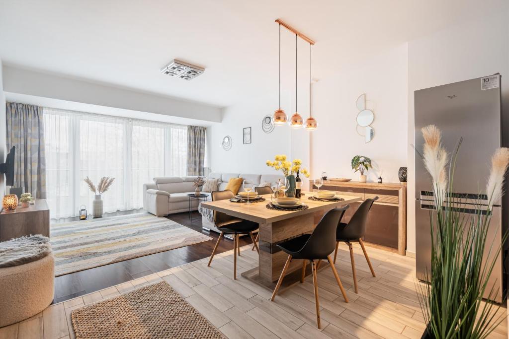 a kitchen and living room with a table and chairs at Premier Pest Side Apartment in Budapest
