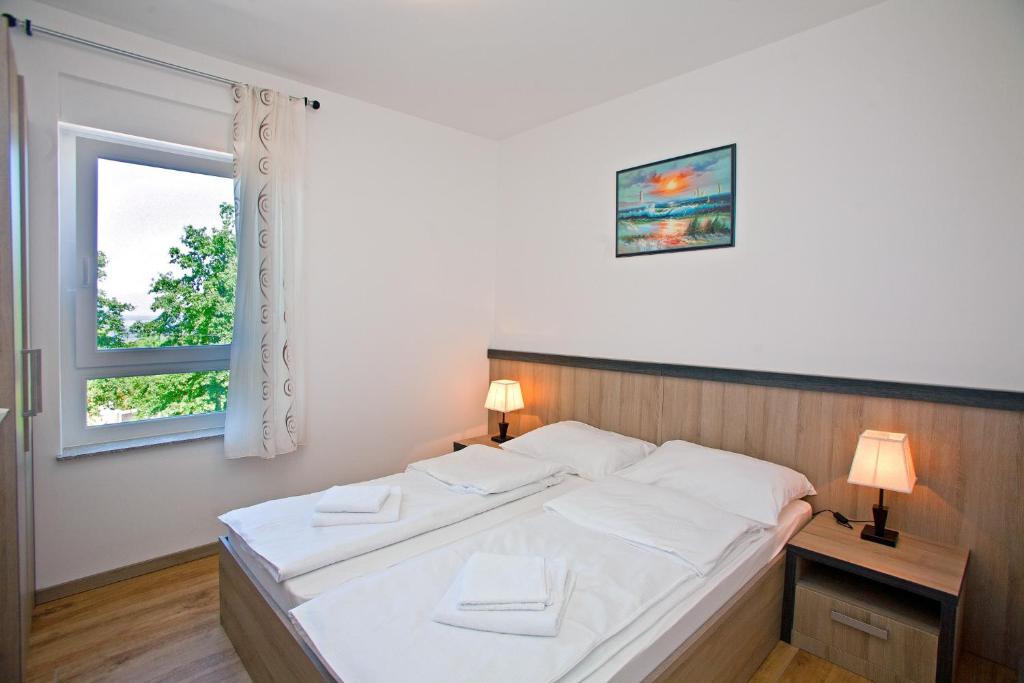 Posteľ alebo postele v izbe v ubytovaní Apartments Maslina I